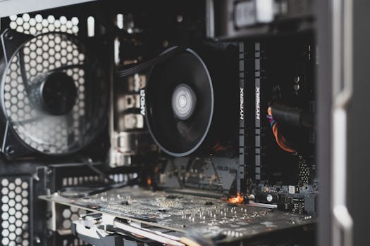 Detailed view of internal computer hardware showcasing cooling fan, RAM, and circuitry.