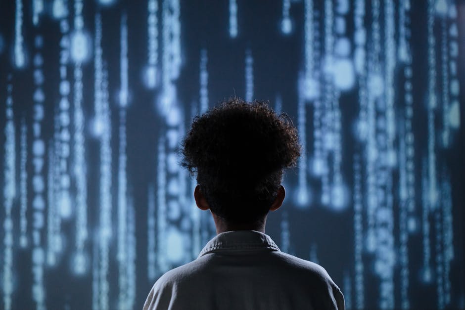 A young boy viewing a digital screen with data streams, symbolizing technology interaction.